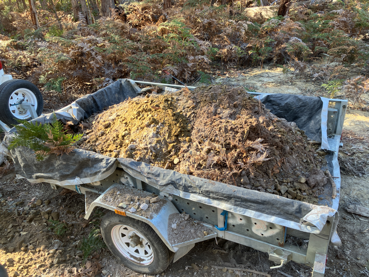 A mixed trailer-load of soil, rock, and road-base