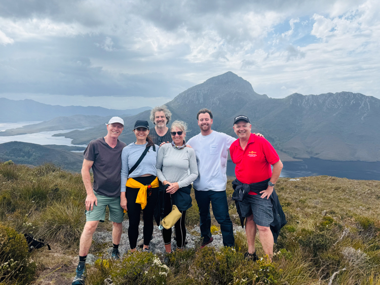 Brendon, Mish, Reinhard, Ange, John and Stu up Mt Beattie in Bathurst Harbour, with Mt Rugby in the background