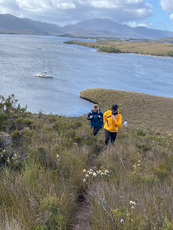 Climbing the lower approaches of Mount Rugby in Bathurst Harbour, with Silver Fern anchored below