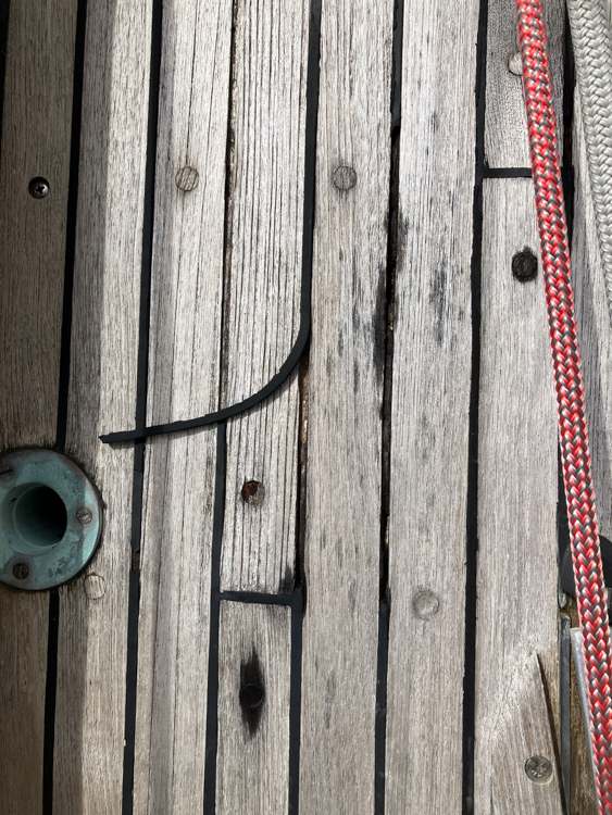 Worn teak decks on Hallberg Rassy 42