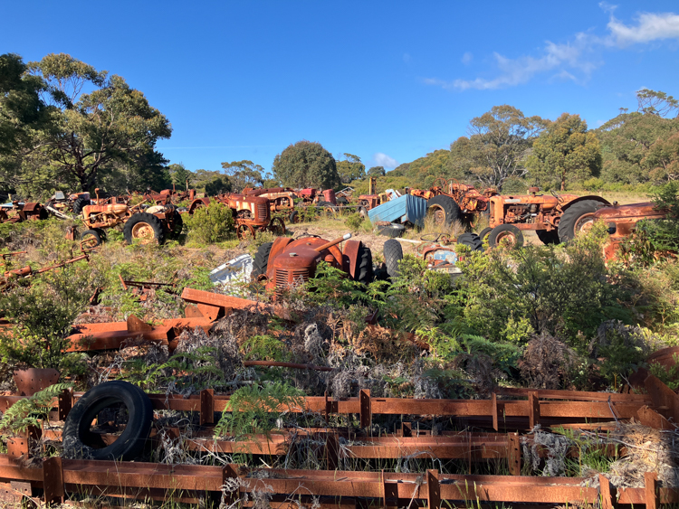 A field full of rusting tractors on the way to Maingon Bay