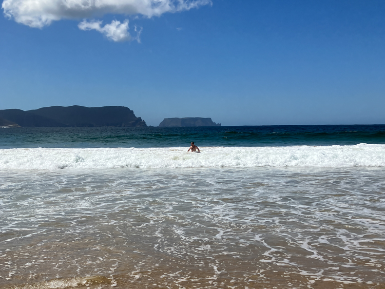 John at Crescent Beach with Cape Pillar and Tasman Island behind