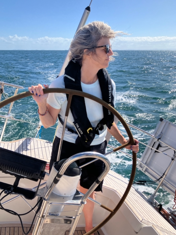 Bronwyn at the helm, sailing to Moreton Island